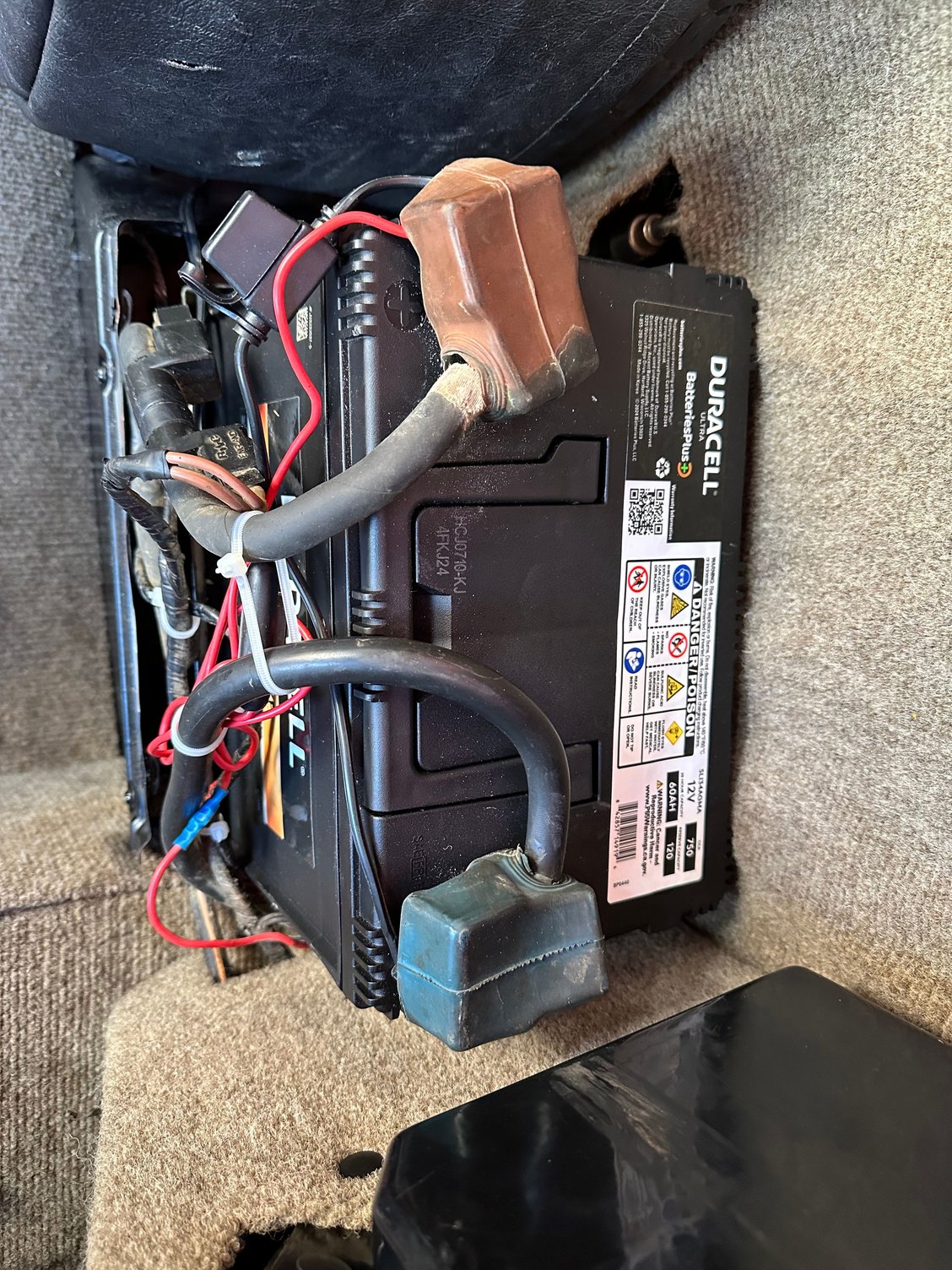 This is the new battery installed. Positive terminal on the left. I have the battery tied down with J Bolts and a metal bar across the top. The XJS plastic cover fits nicely over this battery. 
