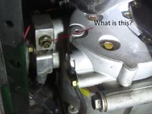 Under car looking upwards at AC compressor.