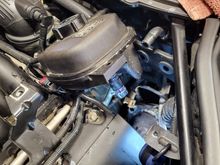 Main hose at bottom of coolant reservoir shows obvious signs of leakage.