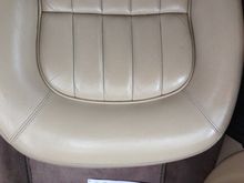 There were two big cracks along the knee padding that ran front to back that are not really visible anymore, and the color is even between the seat and the back on both the left and right, bottom and top.