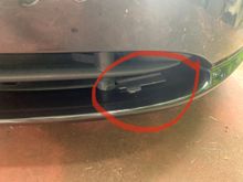 What is this but if plastic sticking out above the front lip. Is it meant to be there or has somebody incorrectly reinstalled the front bumper? 