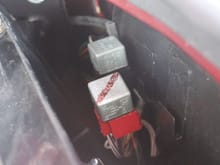 The Red Relay is the Main Relay and the Black Relay is the Fuel Pump Relay.
You can leave the Plastic Cover in place unless you are planning to change one.