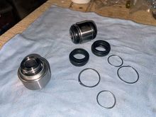 The new spherical bushes, one intact and one with the grease boots removed. Note almost no grease in the new bush.
