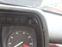 Only 5 Screws hold it in but these two are hidden behind two plastic covers which can be popped out easily with the end of a table knife