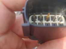 view of connector from the other side - top left pin is the one that needs a new wire.  top center more gold color is the yellow/now red new connection - it appears the pin was also replaced