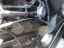 You might be able to see where the coil cover plastic stud inserts in the mounting holes in this left side photo