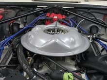An late 60's Corvelle drop base air cleaner base is used to lower engine profile