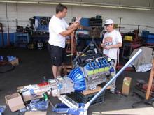 So, there it is, already for installation.  Here is my brother chatting with Luke, the owner of the company who produces the Lister replicas, who is explaining the "simple" technique of slipping the engine and trans into the body shell:

Piece of cake - lets get started!