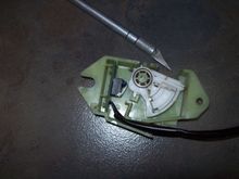 White spring loaded ratchet mechanism as switch actuator, in fully compressed condition.