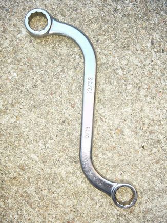 S shaped wrench did the trick, the way the engine bracket is made I couldn't get a ratchet on it. Tried everything else I had...Murphy's Law