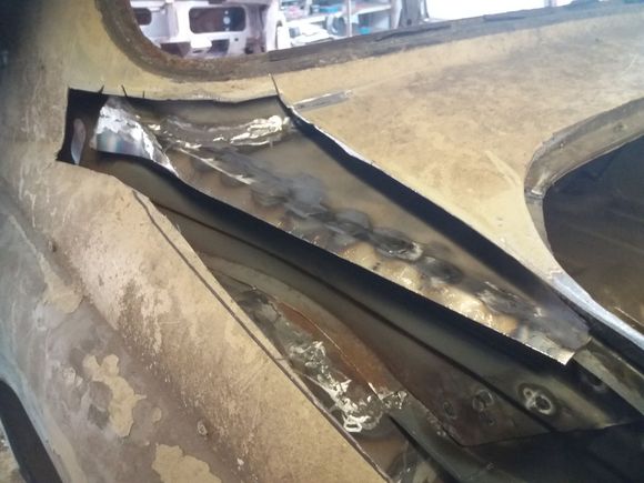 Hole cut in N/S rear wing to repair area underneath properly (the piece removed has now been welded back in.