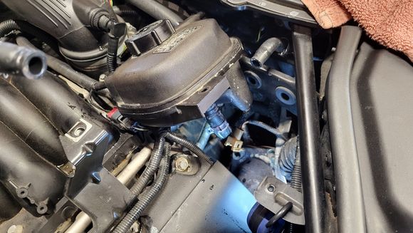 Main hose at bottom of coolant reservoir shows obvious signs of leakage.