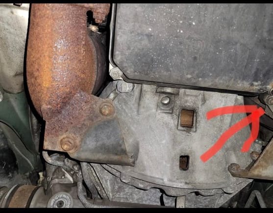 From your perspective, that arrow is pointing towards the passenger side a T25 or T30 Torx screw. Remove that screw and I believe you just pull down on the gray/silver fiberglass panel. 