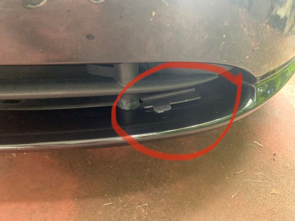 What is this but if plastic sticking out above the front lip. Is it meant to be there or has somebody incorrectly reinstalled the front bumper? 