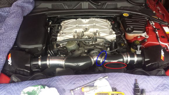 I had to cut about 3/4" of hose from this end (blue oval) because there was a bad kink in that portion of the intake. This intake was for a XFR. I have good clearance around all the intake parts except for where it is slightly touching the air snorkel (red oval). Don't know if this will cause an issue.