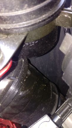 Bottom of canister in top of picture. Part of air intake tube in lower part of picture. Both have signs of the same "stuff" that looks like it has been sprayed on (no dripping/running). It's not much and hard to see.