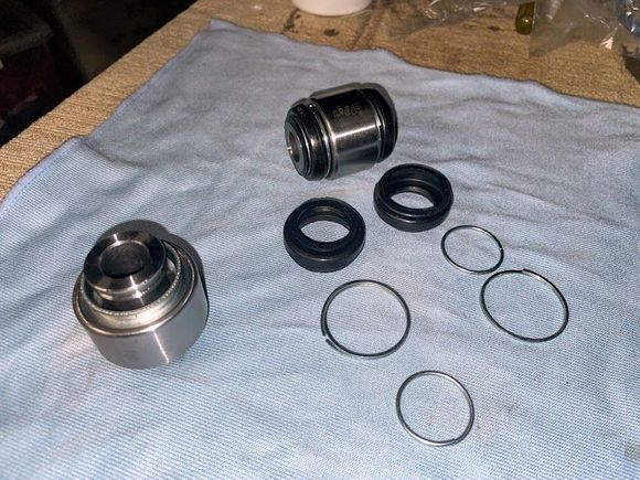The new spherical bushes, one intact and one with the grease boots removed. Note almost no grease in the new bush.
