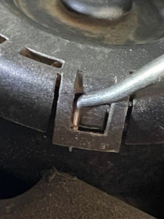 Using the pick, you can pull the clips away while placing a slight upward pressure to remove the cap.