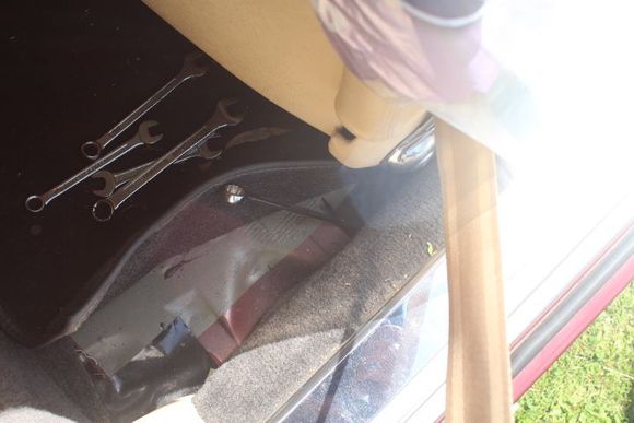 The Handbrake Adjustment Rod is just behind the Drivers Seat underneath the Carpet Trim and can be a bit hard to find