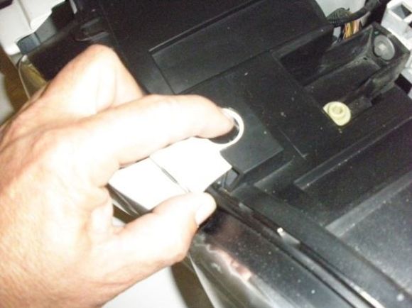 Push on black locking button and pull on bumper cover tap.