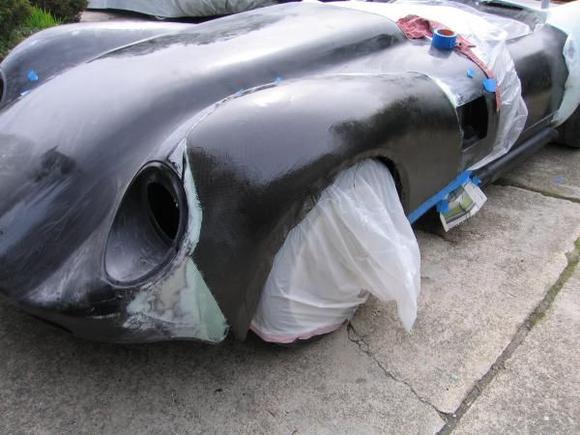 with a good fit using the cloth, we applied the vinylester resin to permanently laminate the carbon skin to the body.  Now it was finally staring to look like all of our work would pay off!