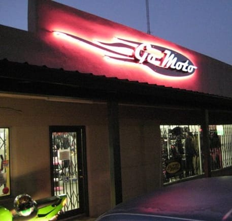 Go Moto store front at night.