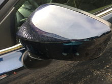 Driver side mirror warped near attachment, and also the black trim on mirror is wavy
