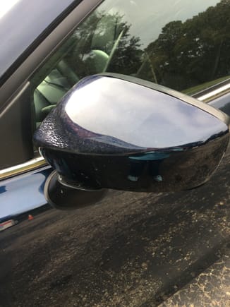 Driver side mirror warped near attachment, and also the black trim on mirror is wavy