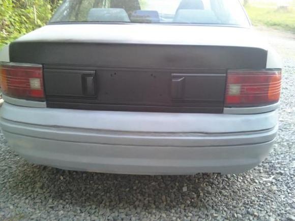 Changed out the center license plate area on the trunk for the 1990 one and painted it all satin black! Looks nicer in my eyes