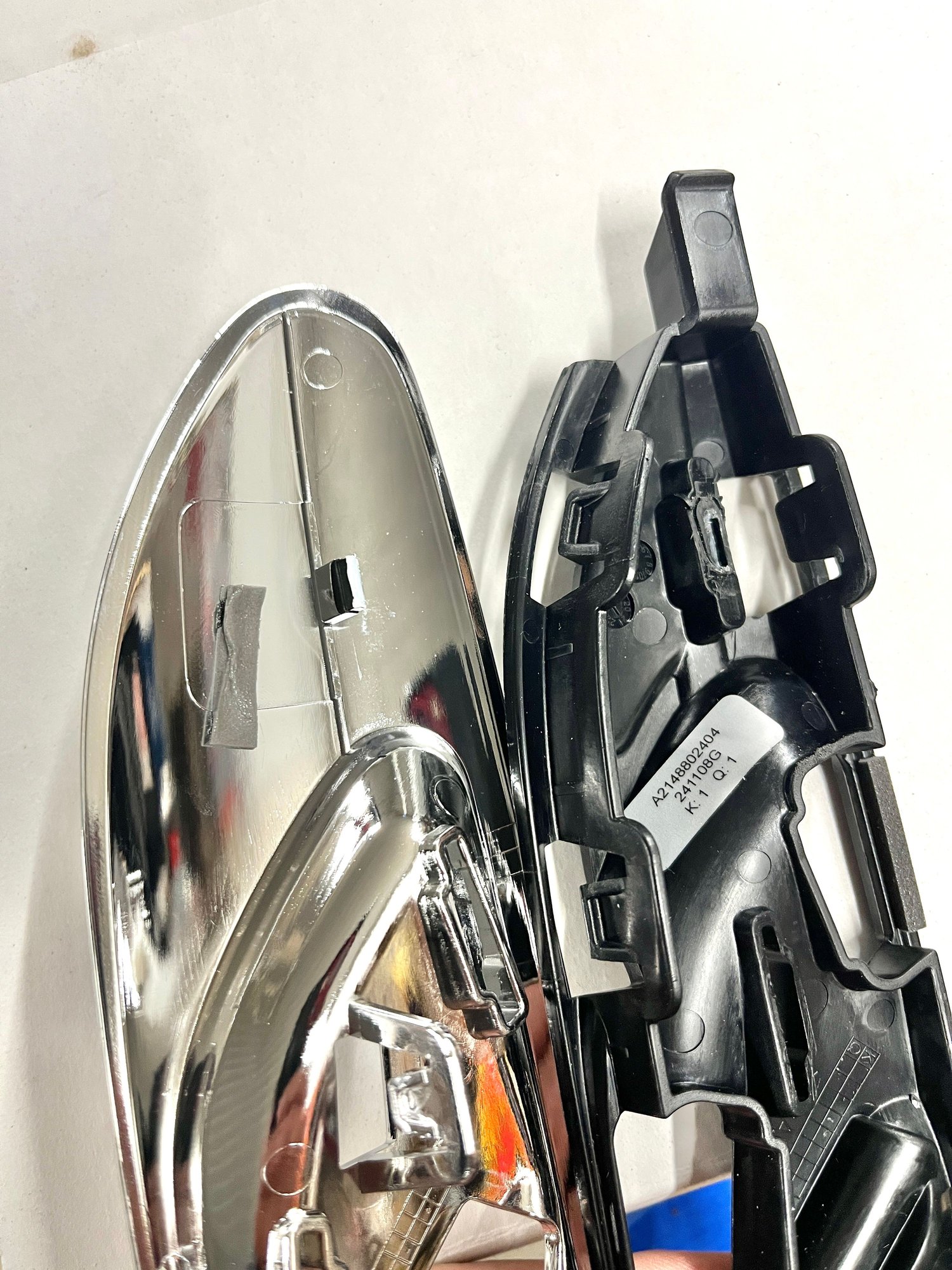 Chrome trim separated from black base.