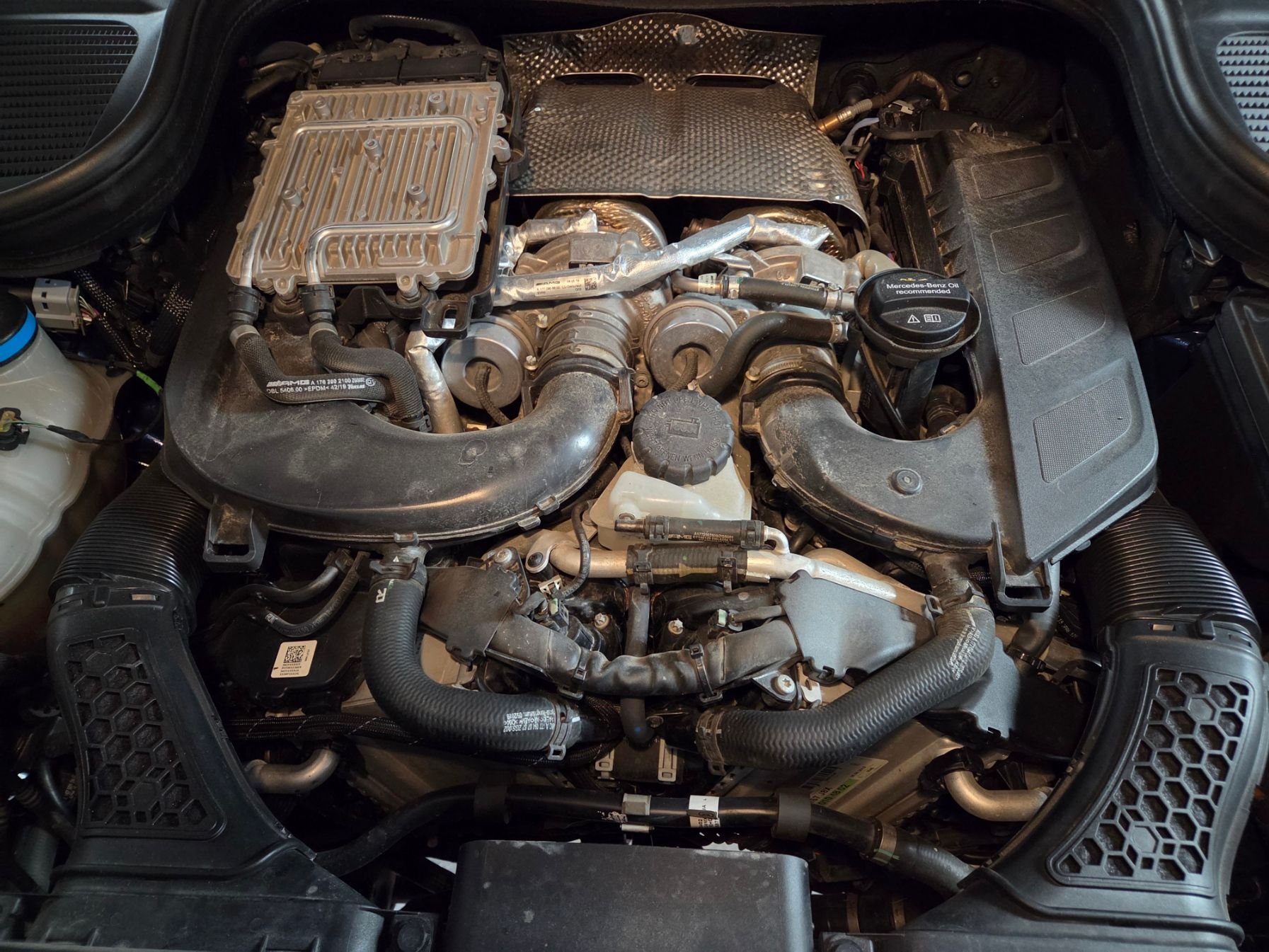 Coolant tank on top of engine in front of the turbos