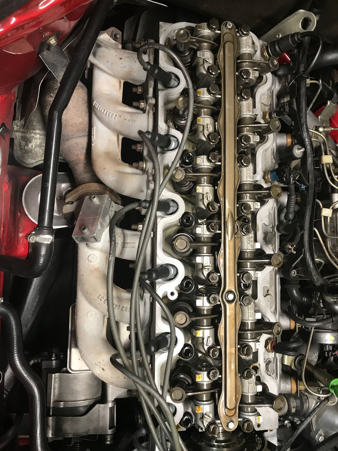 This one has both a V-washer and a bolt towards cylinder one. 