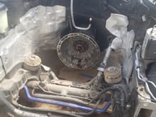 The engine is pulled, my dad did this while i was at work. You can see where the oil pan is split in to sections, a little bit sits up front just in front of the purple sway bar while the rest sits behind the front axle in front of the tranny. Which is why the oil pan and pump needs to be switched