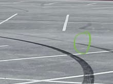 Notice how the outside tire mark drastically lightens as the car turns while the inside mark stays dark. 