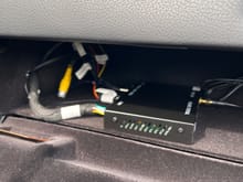Picture of glove box with cables thru the knockout. 