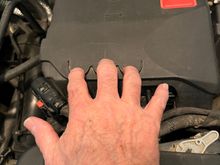 The battery is under the cover with the jump start positive connection. Pull toward you with the 3 semicircular finger grips.