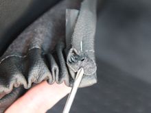 Looks like the plug or whatever it was broke off. It has a hole in the center so maybe there was a screw holding it from the inside of the seat back.