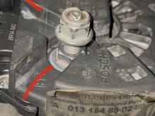Original Bosch alternator with the 2 slots in the plastic housing that the battery cable slides into and connects to the bolt
