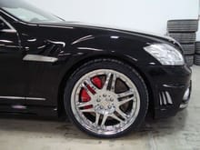 Close up of Black Bison Fender and Front Bumper, custom painted calipers, and 20&quot; BRABUS Monoblock VI chrome wheels