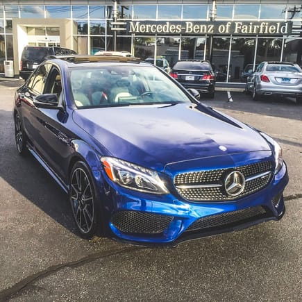 2017 C43 Brilliant Blue at Mercedes-Benz of Fairfield, outside late afternoon.