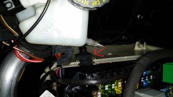 Place the square rubber stopper from the Y harness into the side wall of the SAM box. NOTE: Makes sure you insert it the right way. The rubber stopper for the wiper motor needs to sit on top of it.
