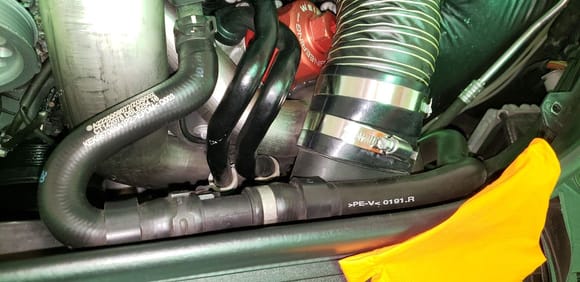 Disconnect the oil cooler lines from the oil filter housing an this coolant hose at this clamp to gain access to the turbo air ducting on the driver side