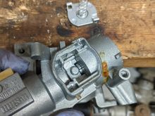 If you don't want your key to get stuck in lock cylinder (preventing you from shutting off car) then put it into run mode and hotglue that mechanism that can rattle around in place.  Figure out the right spot first, it should be obvious.