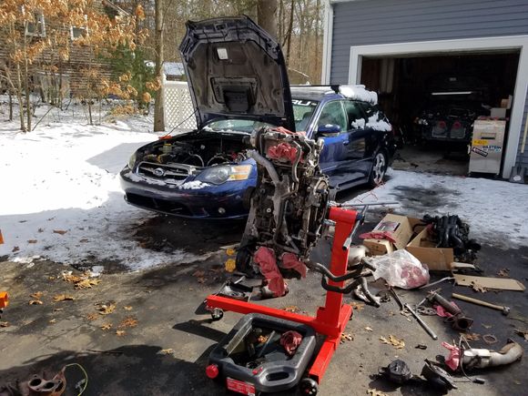 Resealing and rebuilding kelseys motor outside.