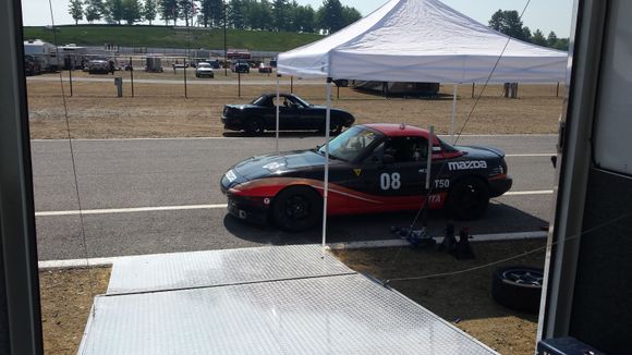 Maggie and the cheetah miata last summer at NHMS for a track weekend.  First time we got to use the new tow setup.  2008 volvo semi truck with sleeper cab.  Air conditioned car hauler trailer with a lift built in.  We brought 4 miatas that weekend in that trailer.  Hanging a hammock between the lift uprights made a great place to sleep.