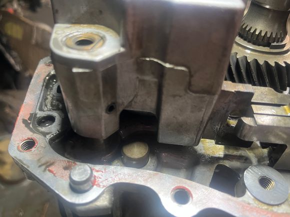 I believe that as long as the sensor is to the rear of this notch in the 6th gear shift fork (rear being “above” in this photo) it won’t interfere with the rod.