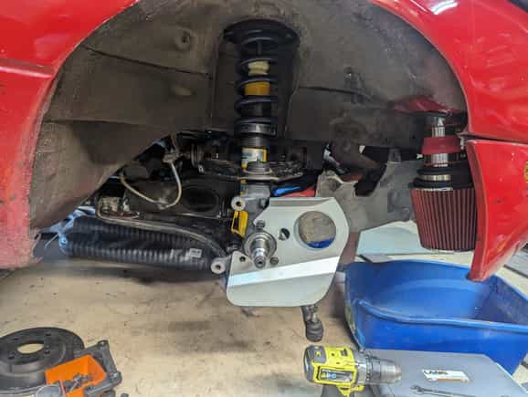 Back together and now waiting on hubs from Brofab.  Singular Motorsports 3" brake duct kit (I added the 3rd heatshield bolt after the picture).  700lb 7" hypercoils on the NB Bilsteins.  Torrington Bearings, 36mm bump stops (didn't have bump stops before), NB top hats.  Enough to get the cobwebs off before I upgrade suspension further.  Poly bushings throughout, 949 racing ELBJ, 949 racing alignment bolts.  Still need to make ducts and install the 1.8 front brakes (GLOC R10 pads)