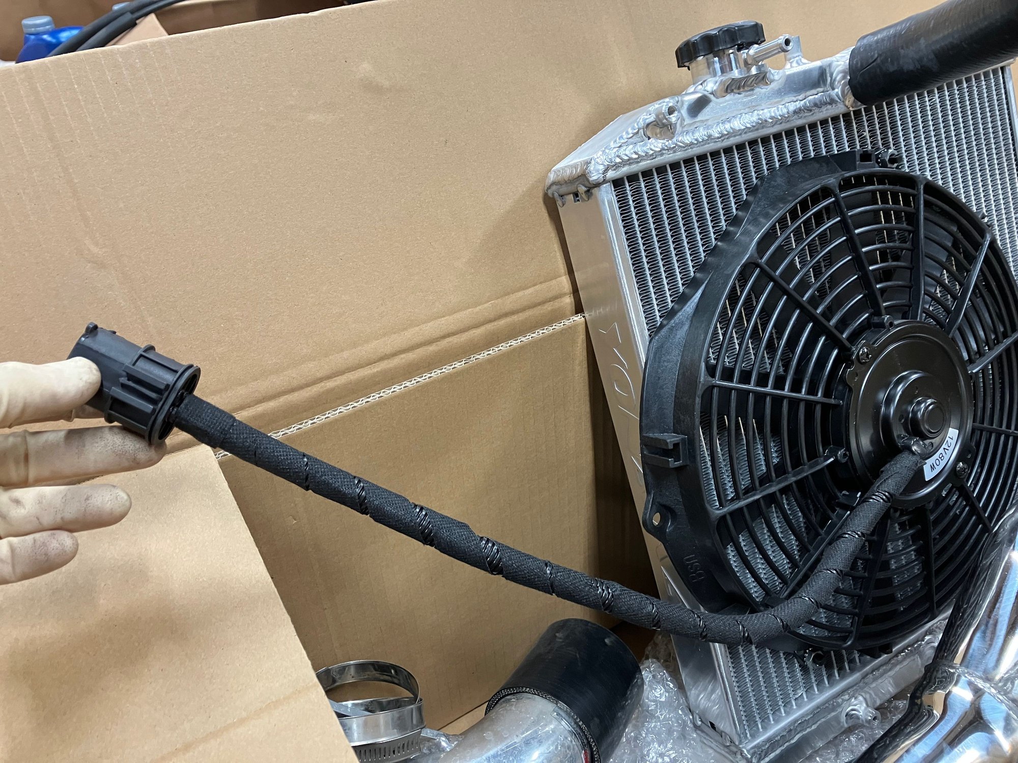 Add some wiring loom cover and it looks pretty factory and you retain the factory plug so if you ever need to remove the radiator you can do so with out having to mess with the wiring.