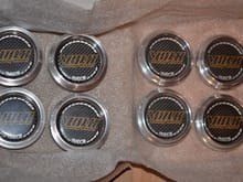 Two different sets of center caps. Left set with a higher profile the right side is the lower profile. Both sets included with purchase. 