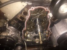 Unbolt the cam gear.... And wiggle it off the cam, you are going to need a heat gun or really hot hair dyer to heat the tnesioner up and make it pliable so you can compress it and put a pin or small allen key in it to keep it compressed....